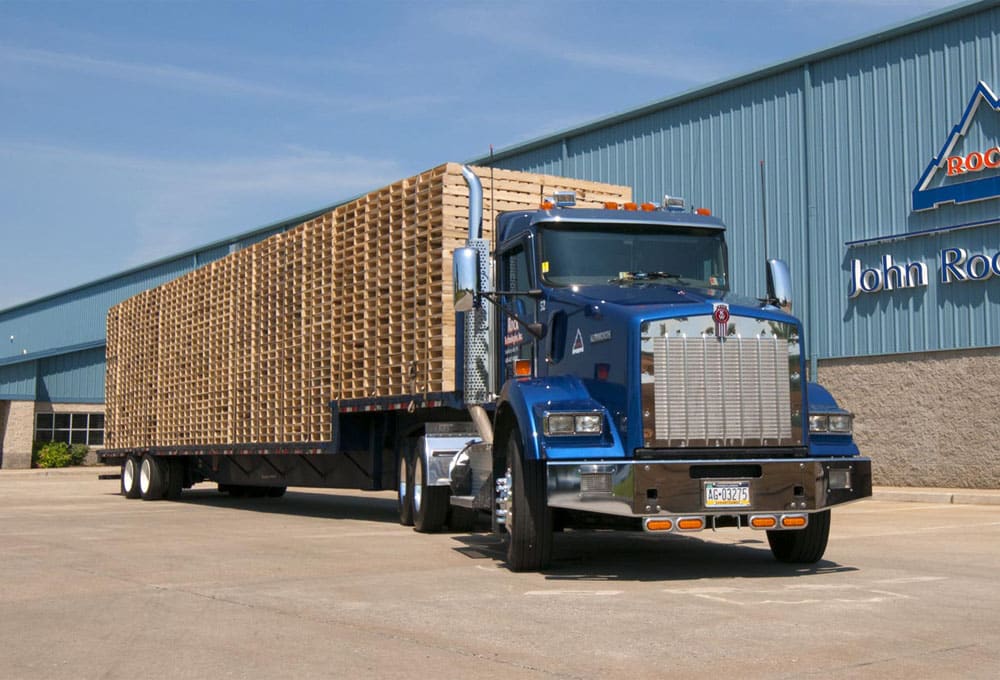 John Rock, A Kamps Company semi with a trailer of new wooden pallets