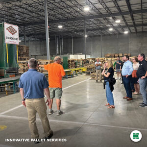 Men and women touring pallet manufacturing facility in Council Bluffs, IA.